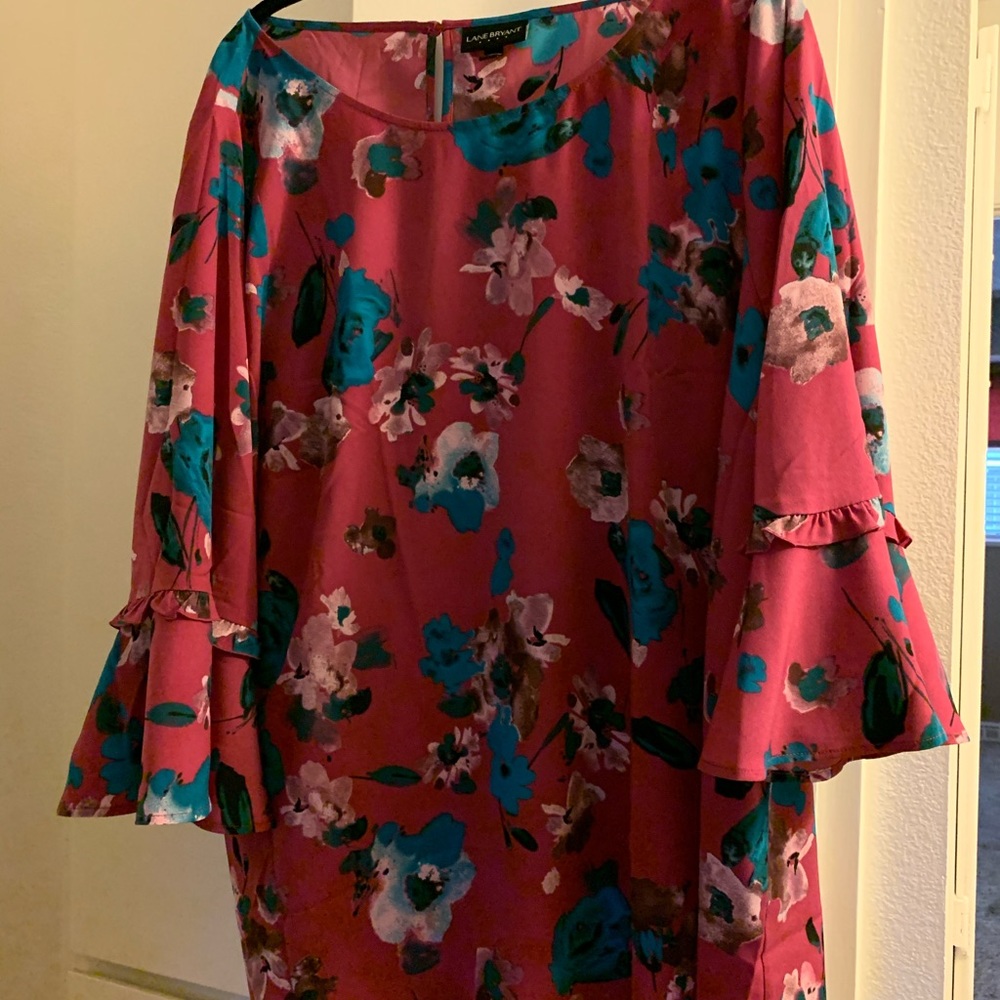 Pink floral blouse with ruffle sleeves.